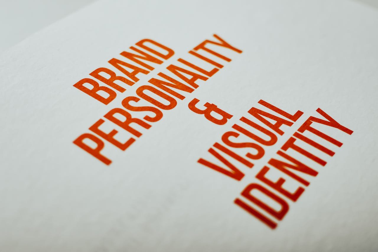 team-06 Close-up of 'Brand Personality & Visual Identity' text in red on white paper.